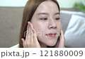 Relaxed woman savoring morning beverage in cozy bed. 121880009