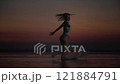 Woman Dancing Freely in Sunset Waters 121884791