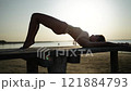 Elegant Arching Pose at Sunset Beach 121884793