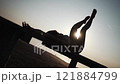 Woman Relaxed Pose with Raised Legs at Sunset 121884799