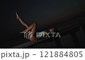 Woman Reclining Elegantly on a Pier at Twilight 121884805