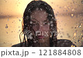 Woman Immersed in Water Spray at Sunset 121884808