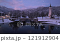 Aerial view of lake in alpine town at winter night in snowfall 121912904