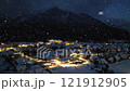 Aerial view of mountain village in snowfall, city lights at night 121912905