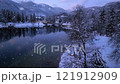 Aerial view of lake in alpine town at winter night in snowfall 121912909