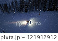 Aerial view of snowcat. Snowy alpine ski slope at night. Snowfall 121912912