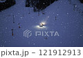 Aerial view of snowcat. Snowy alpine ski slope at night. Snowfall 121912913