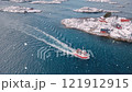 Aerial view of fishing boat, blue sea and islands in snowfall 121912915