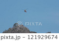 helicopter flying near high mountain 121929674