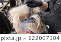Hair highlighting procedure in a beauty salon - Woman getting her hair coloured 122007104