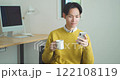 Young man sitting on a sofa and using a smartphone 122108119