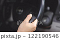 Footage Close up, A woman holds the key in her hand and presses the key open button to start the engine and prepare to leave. VDO 4K resolution. concept of Vehicles, Travel, Safety, Driving. 122190546