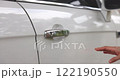 Footage Close up. A woman open the car door and gets into the driver's side of the cabin, closes the door to prepare to start the engine. VDO 4K resolution. 122190550