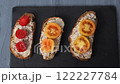 Three sandwiches with pate and tomatoes fly away, take the top view on a gray background from the frame. 122227784