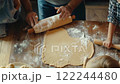 Family Baking: Rolling Dough Together 122244480