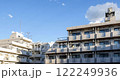 Timelapse of sunlight shifting across modern apartments under a clear sky. Japan 122249936