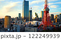 Tokyo Tower glows red beside glassy skyscrapers, golden light at sunset, Japan 122249939
