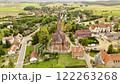 Aerial view of a historic church and picturesque village in Poland surrounded by green countryside 122263268
