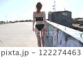 back view of woman walking wearing underwear on an empty building roof 122274463