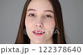 Young beautiful woman winks playfully 122378640