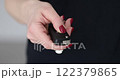 Woman pressing a button on car key fob 122379865
