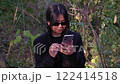 Amazed woman celebrating good news on her smartphone, expressing joy and triumph. Perfect for concepts of success, achievement, and positive surprises. Ideal for portraying winning moments 122414518