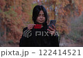 In park, a woman using her credit card and smartphone, finalizing a quick and safe transaction. 122414521