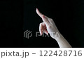 Making a touching gesture with your index finger 122428716