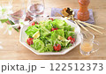Green salad, frilly lettuce, avocado, radish sprouts, cherry tomatoes. The white flowers are artificial. 122512373