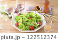 Green salad, frilly lettuce, avocado, radish sprouts, cherry tomatoes. The white flowers are artificial. 122512374