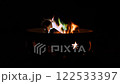 Bonfire fire pit with sky stars cutouts at night camping. Beautiful flame with different color 122533397