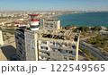 AKTAU, KAZAKHSTAN - FEBRUARY 1, 2025: Aerial view of abandoned buildings overlooking the Caspian Sea with cityscape in the background 122549565