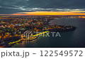 AKTAU, KAZAKHSTAN - FEBRUARY 1, 2025: Stunning aerial view of Akatau skyline during sunset showcasing vibrant city lights and serene coastline 122549572