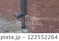 Drainpipe connected to the red brick building 122552264