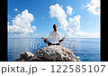 Woman yoga on the rock facing sea view and horizon. 122585107