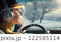 A woman wearing Virtual Reality glasses driving a car, technology concept. 122585114