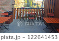 Outdoor seating area with tables, the camera rises higher and focuses on the balloon 122641453