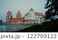 Historic mir castle reflecting in misty lake 122709122