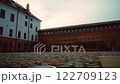 Historic brick and stone courtyard at dusk 122709123