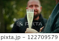 Celebrating outdoors with sparkling champagne glass 122709579