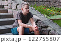 Sad depressed teenage boy alone on steps outside, feeling angry and lonely 122755807