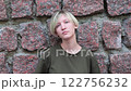 Portrait of a teenage girl against the background of a stone wall. Close up 122756232