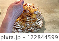 Dusting Freshly Prepared Pastry with Powdered Sugar on kitchen Countertop 122844599
