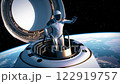 An astronaut steps out of a private spacecraft capsule into outer space and waves in greeting 122919757