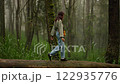 Woman walk in misty forest , Fog magical laurel tree forest with old fairy trees 122935776