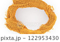 Golden brown granular particles form a textured circular shape against a bright white background, ideal for creative layouts. 122953430
