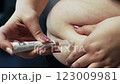 A woman self-injects a semaglutide antidiabetic drug into her stomach, used to treat diabetes and obesity. The concept of weight loss and healthy lifestyle 123009981