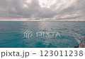 A small boat is gently floating serenely on top of a large body of water 123011238