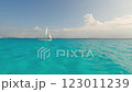 A sailboat glides through turquoise waters, showcasing serene adventure 123011239