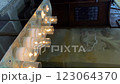 White candles flicker in a dark interior of the church, selective focus, vertical format 123064370